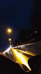 Wet nighttime road conditions documented by motorist