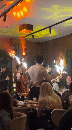 Moscow restaurant staff deliver sparkler dessert to celebrating diners