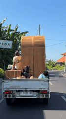 Furniture delivery truck spotted carrying wooden wardrobes in North Kuta