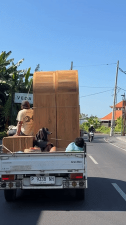Furniture delivery truck spotted carrying wooden wardrobes in North Kuta