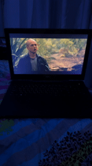 Laptop plays forest movie scene in Mũi Né bedroom