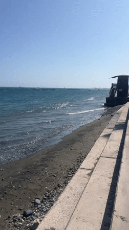 Sunny afternoon stroll along the Agios Tychona beachfront promenade