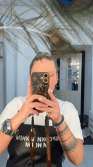 Person takes playful selfies in mirrored commercial space