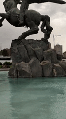 Winged equestrian monument and spired building in central Yerevan