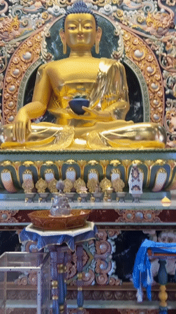 Golden Buddha statue with ornate backdrop documented in Russia