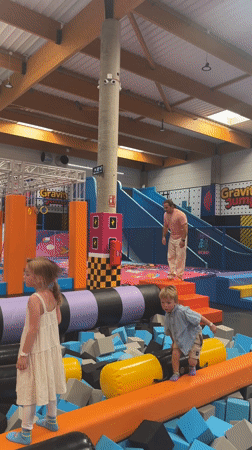 Man practices gymnastics at indoor trampoline park in Spain