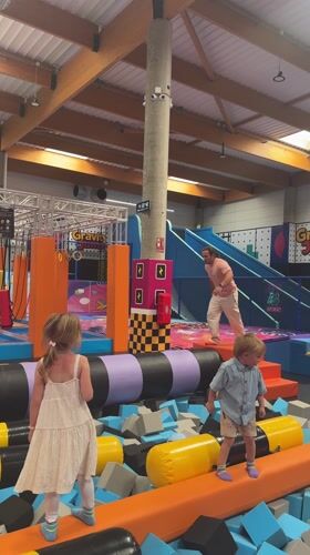 Man practices gymnastics at indoor trampoline park in Spain