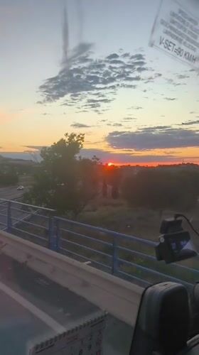 Sunset highway view captured from moving vehicle near Museros