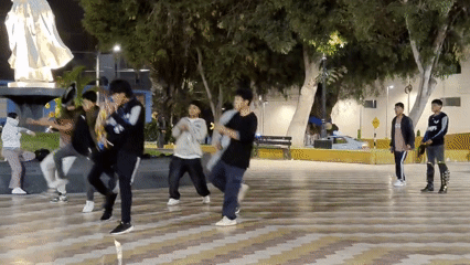 Dance groups perform coordinated routines in Tacna plaza overnight