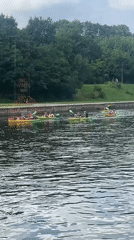 Kayaking a calm Vilnius river on a cloudy summer day