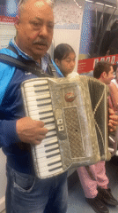 Street musicians perform on subway trains amid routine city life