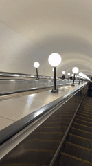 Moscow subway escalator with spherical lights captured on video