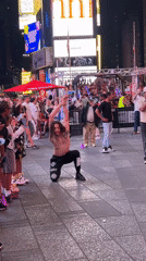 Acrobatic street crew performs for a late-night Times Square crowd