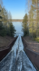 Dual water streams flow through metal channel toward lake