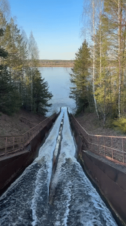 Dual water streams flow through metal channel toward lake
