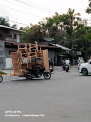 Street vendors operate motorcycle furniture transport, food cart in Lhokseumawe