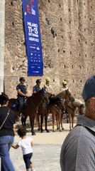 Morning at Sforza Castle: mounted police, tourists, and architecture