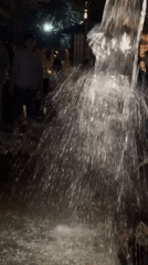 A summer evening at a lit-up outdoor park in Shymkent