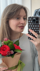 Woman takes selfie with rose bouquet in Izhevsk