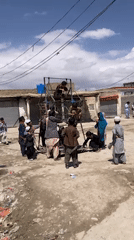 Children gather around makeshift Ferris wheel in Quetta