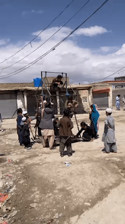 Children gather around makeshift Ferris wheel in Quetta