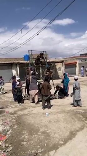 Children gather around makeshift Ferris wheel in Quetta
