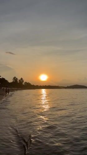 Golden hour on a Ko Samui beach with jet ski action