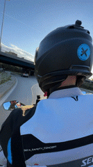 Motorcyclist travels through Sofia streets wearing black helmet