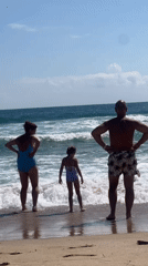 Family beach morning in the shallows at Sozopol, Bulgaria