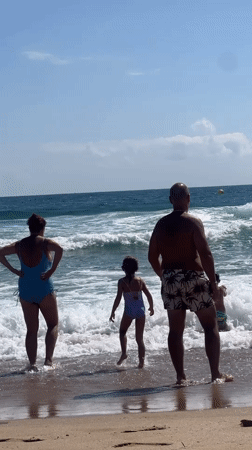 Family beach morning in the shallows at Sozopol, Bulgaria