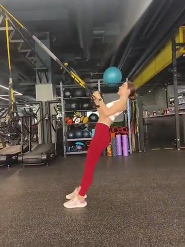 Woman performs early morning TRX workout session in Tyumen gym