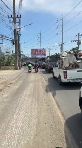 Motor scooter records street traffic in Chalong, Thailand