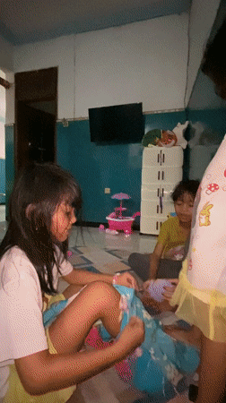 Two girls in hallway, one wearing Belle character clothing