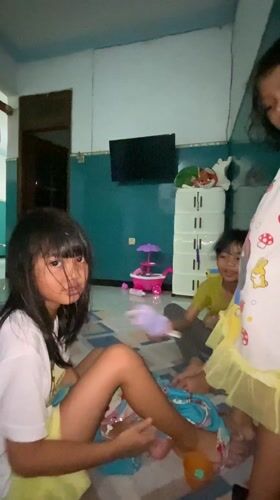 Two girls in hallway, one wearing Belle character clothing