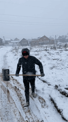 Man shovels sawdust during heavy snowfall near Sarapul, Russia