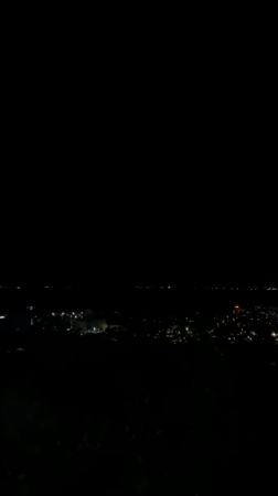 Nighttime views over Silistra from a grassy hillside overlook