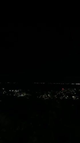 Nighttime views over Silistra from a grassy hillside overlook