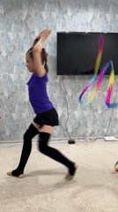 Young gymnast practices rhythmic routines at home in Russia