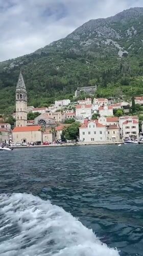 Boat passenger films scenic view of Perast, Montenegro
