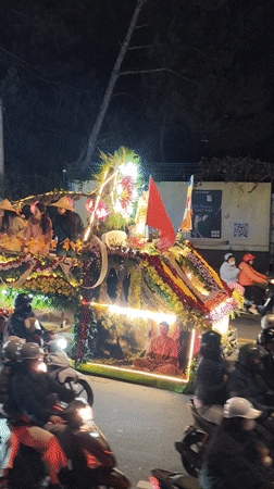 Illuminated religious procession with decorated floats travels through Da Lat