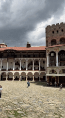 Tourists visit historic Rila Monastery amid overcast spring weather