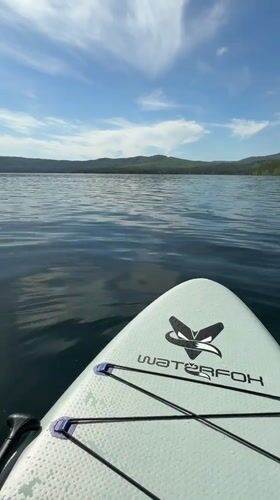 Beach recreation documented at Russian lakeside resort during morning hours