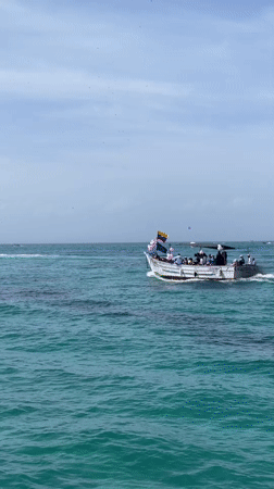 Festive boat outing on turquoise waters near Porlamar, Venezuela