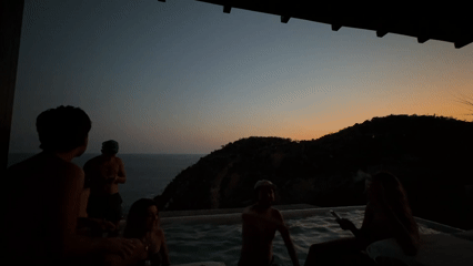 Poolside gathering captured during sunset in Puerto Marqués, Mexico
