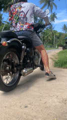 Motorcyclist spotted on tropical roads in Kabalana, Sri Lanka