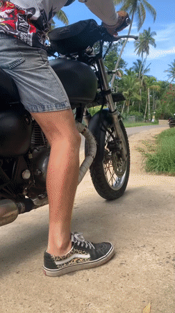 Motorcyclist spotted on tropical roads in Kabalana, Sri Lanka