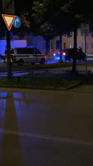 Police van with flashing lights parked on Munich roadside