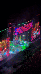 Milan indoor concert lights up with crowd, screens, and full production