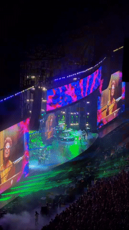 Milan indoor concert lights up with crowd, screens, and full production