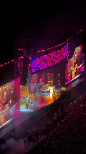 Milan indoor concert lights up with crowd, screens, and full production